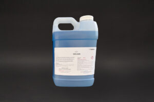 gallon of blue liquid from the EZClean–Soap 5-1 sitting on top of a table